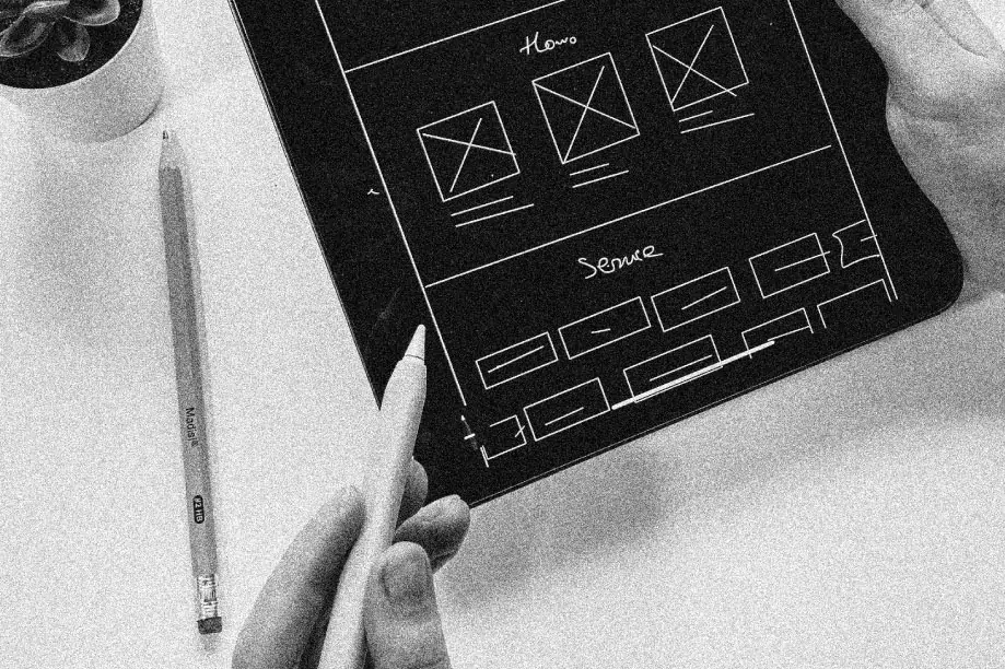 A person creating a general layout for custom software on a drawing tablet.